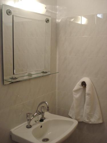 a bathroom with a sink and a mirror and a towel at Veroniki Apartment in Skala Marion