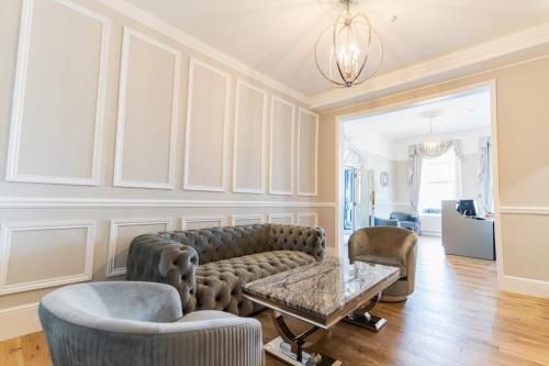 a living room with a couch and chairs and a table at The Pier Hotel in Eastbourne