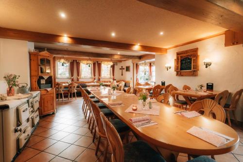 a large dining room with wooden tables and chairs at Landgasthof Zum Stern Wasserkuppe Rhön in Poppenhausen
