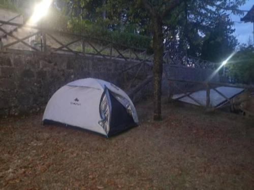 a tent sitting on the ground next to a tree at POGGIO ECO B&B in Ascoli Piceno