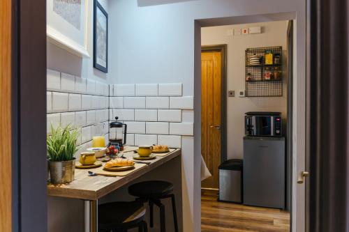 a kitchen with a counter with food on it at By the Way in Great Malvern