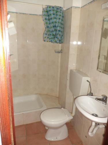 a bathroom with a toilet and a sink and a tub at Casa do João in Barão de São João