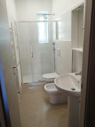a bathroom with a shower and a toilet and a sink at Casa Minù in La Spezia