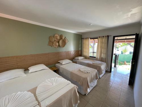 A bed or beds in a room at MUTA PRAIA HOTEL