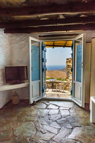 an open door to a patio with a view of the ocean at Spiti Anita, Superior Master & Double Room - Pristine, Serene, Beautiful Views in Gavrion