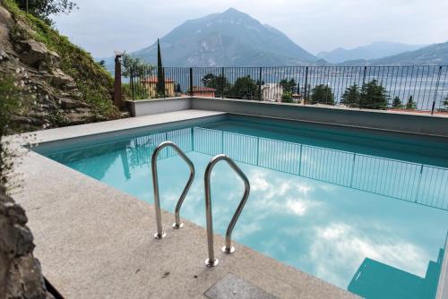 a swimming pool with a view of a mountain at Residenza Luigina in Varenna