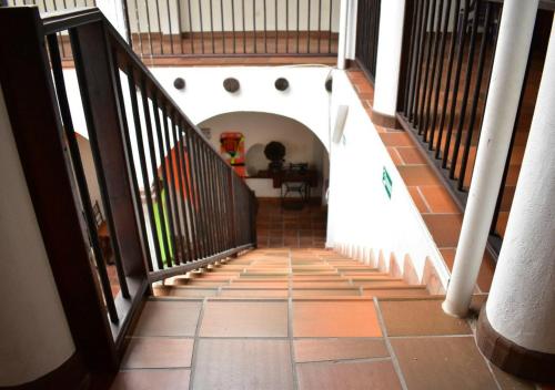 a staircase in a house with a tile floor at Hotel Restaurante Sion in Moniquirá