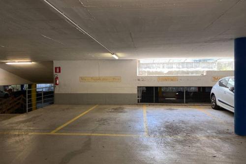 an empty parking garage with a car parked in it at Große Wohnung mit Garagenparkplatz in Vols am Schlern