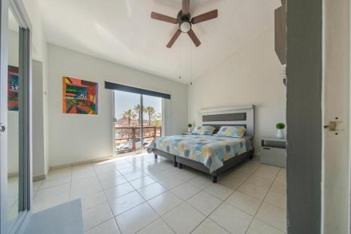 a bedroom with a bed and a ceiling fan at Cabo Kipy in Cabo San Lucas