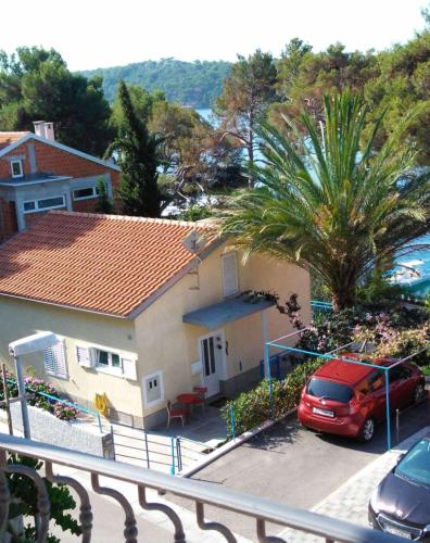 a red car parked in front of a house at Casita Liliana By the Sea in Mali Lošinj