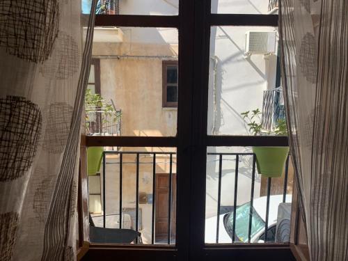 an open window with a view of a balcony at Casa Cinema Paradiso in Cefalù