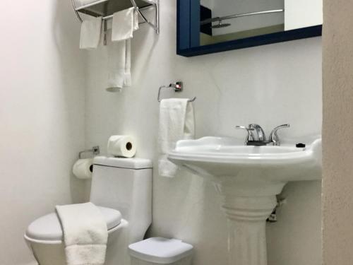 a white bathroom with a toilet and a sink at One Bedroom Condo Near Beach RG6 in Puerto Vallarta