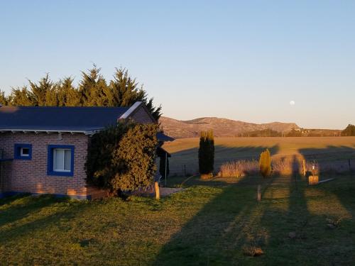 a small house in the middle of a field at Cabañas Arcángeles de Tandil in Tandil