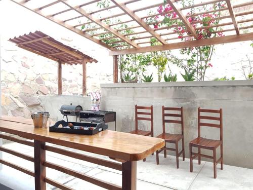 a table and two chairs and a grill on a patio at Bella Vista condominio in Canoas De Punta Sal