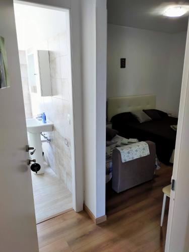 a room with a bed and a bathroom with a mirror at Agriturismo Soleada in Ventimiglia