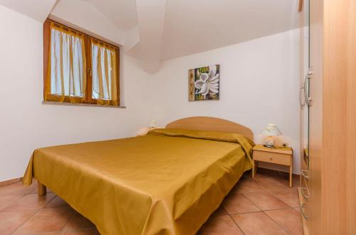 a small bedroom with a bed and a table at Apartments Villa Estella in Srima