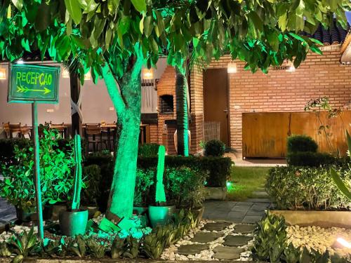 a group of trees with green lights in a yard at Zuri Pousada Maragogi in Maragogi