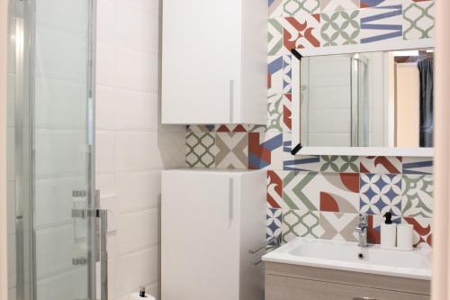 a bathroom with a white refrigerator and a sink at I Tre Cardilli in Matera