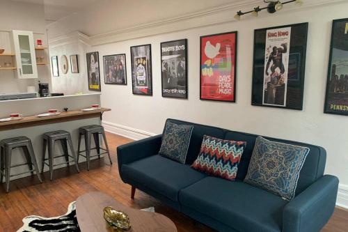 a living room with a blue couch and posters on the wall at Lower east side Nyc in Old Bisbee in Bisbee