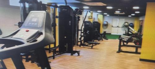 a gym with several treadmills and machines in it at Condominio Barretos Thermas Park - Condohotel 1242 in Barretos