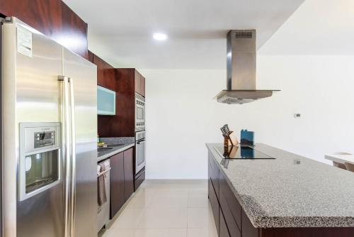 a kitchen with a stainless steel refrigerator at Mareazul Beach Front Condos At playa del Carmen in Playa del Carmen