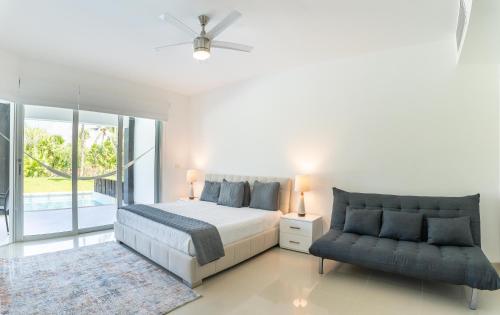 a bedroom with a bed and a couch at Mareazul Beach Front Condos At playa del Carmen in Playa del Carmen