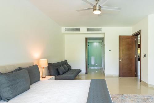 a living room with a bed and a couch at Mareazul Beach Front Condos At playa del Carmen in Playa del Carmen