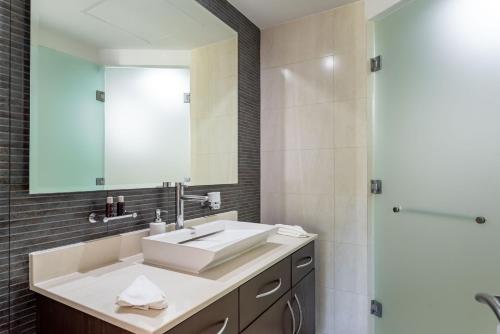 a bathroom with a sink and a shower at Mareazul Beach Front Condos At playa del Carmen in Playa del Carmen