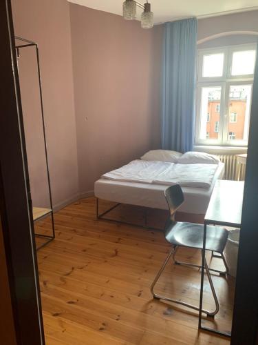 a bedroom with a bed and a chair and a desk at 36 Rooms Hostel Berlin Kreuzberg in Berlin