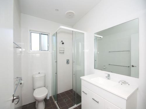 a bathroom with a toilet and a sink and a shower at Ocean Nest Pet Friendly in Hawks Nest