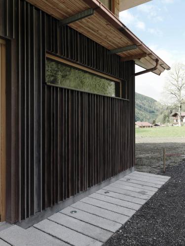 a wooden building with a window on the side of it at Alpenrose Boutique Chalet Gretl in Ramsau am Dachstein