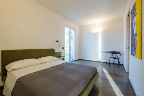 a bedroom with a large bed and a table at Martina's Vineyard - rooms in Marsala