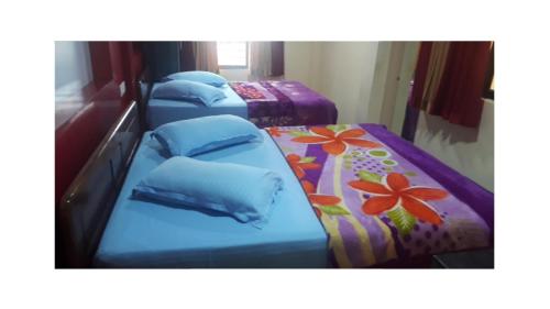 three beds in a row in a room at WILLOW HILL LEISURE HOME in Munnar