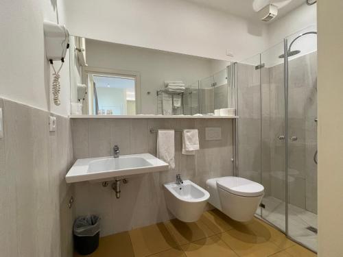 a bathroom with a sink and a toilet and a shower at Hotel City in Rimini