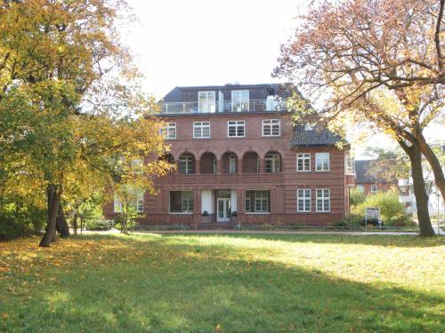 a large red brick building with trees in front of it at Villa Höger in Boltenhagen