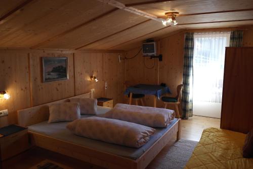 a living room with a couch in a wooden room at Stampferhof in Matrei in Osttirol