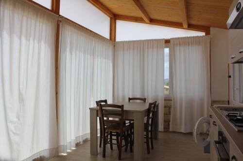 a dining room with a table and chairs at Residence Del Tellaro in Noto Marina