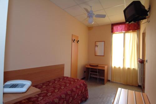 a hotel room with a bed and a television at Hotel San Geminiano in Modena