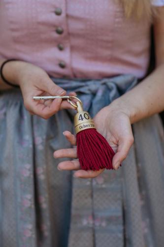 a woman holding a ball of yarn in her hands at Hotel Goldener Ochs in Bad Ischl