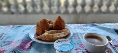 a plate of pastries and a cup of coffee on a table at La Casa di Francesco in Saline Joniche