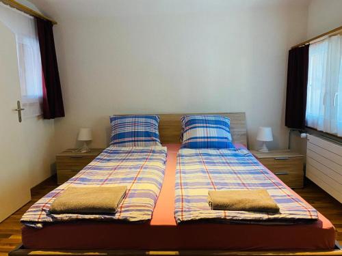 a bedroom with two beds with pillows on it at Royal Swiss Apartments in Ringgenberg