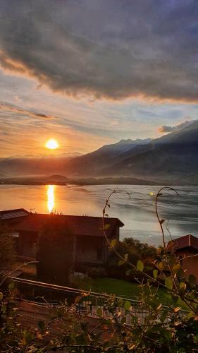 a sunset over a body of water with the sun at Il Giardino Di Lory in Vercana