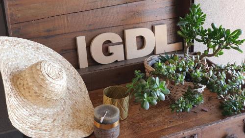 a table with potted plants and a sign on a wall at Il Giardino Di Lory in Vercana