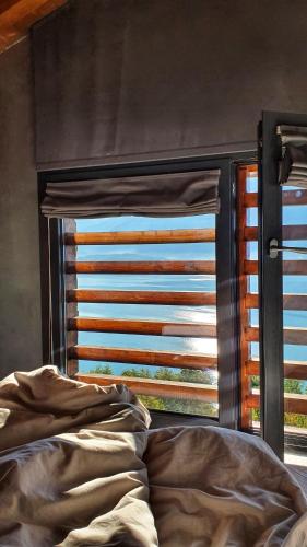 a bed in front of a window with a shutter at Il Giardino Di Lory in Vercana