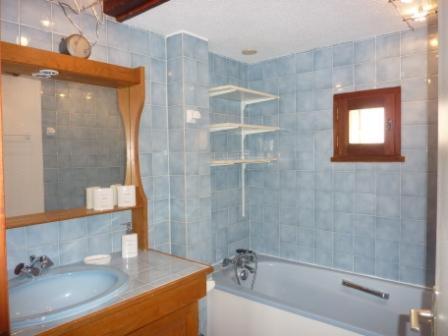 a blue bathroom with a tub and a sink at Magnimon 2 - Appartement rustique dans belle maison de village - Domaine Alpe d'Huez in Villard-Reculas