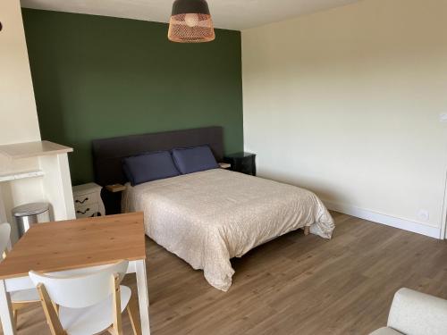 une chambre avec un lit et une table avec des chaises dans l'établissement Cosylocation Jean Bart 74, à Rennes