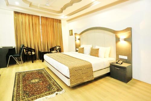 a bedroom with a large bed in a room at Crown Plaza Residency in Srinagar