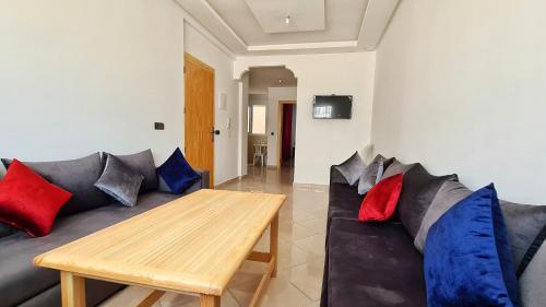a living room with a couch and a wooden table at Enjoy Your Vacation Here, 1 min to The Beach, Only for families !! in Martil