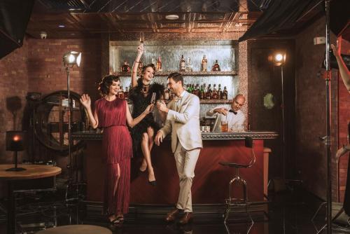 a group of people standing in a bar at Paramount Hotel Dubai in Dubai