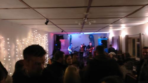 a crowd of people in a room with lights at Old New Inn, Llanfyllin in Llanfyllin